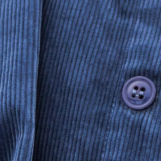 Close-up of a blue corduroy jacket with a button